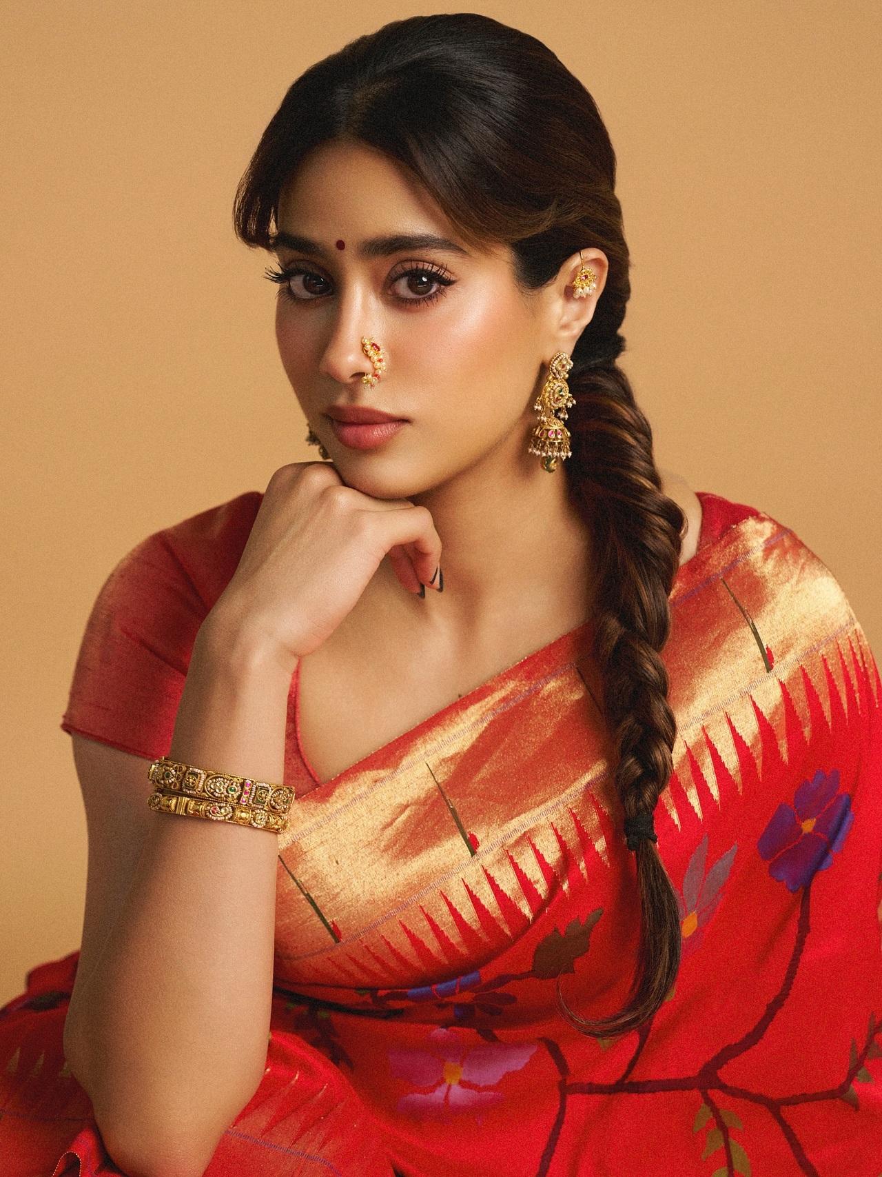 Draped in a stunning red floral saree with golden borders and a classic red blouse, Janhvi looked like a vision to behold. She kept the look minimal yet vibrant with traditional gold earring, bangles, rings and dewy makeup.